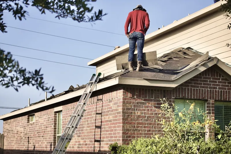 Professional roofer working on a residential roof in Meadow Oaks